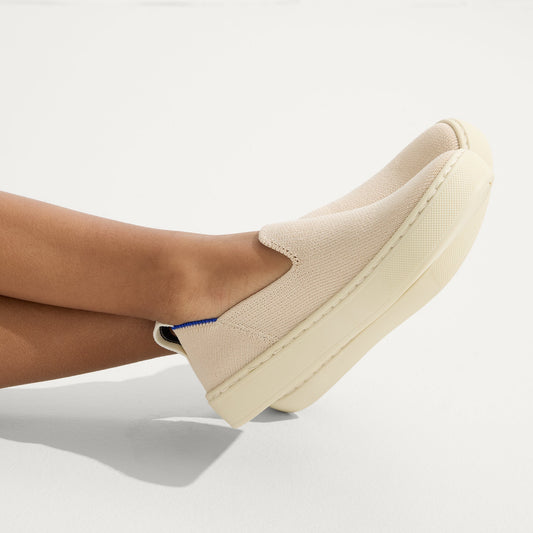 hover | Model wearing The Kids Sneaker in Sand.