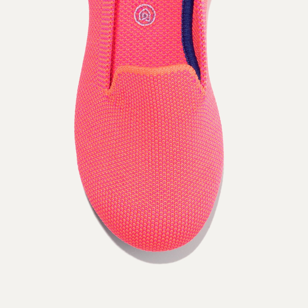 The Kids slip-on Loafer in Flamingo shown from the top view with detailing of the front of the shoe.