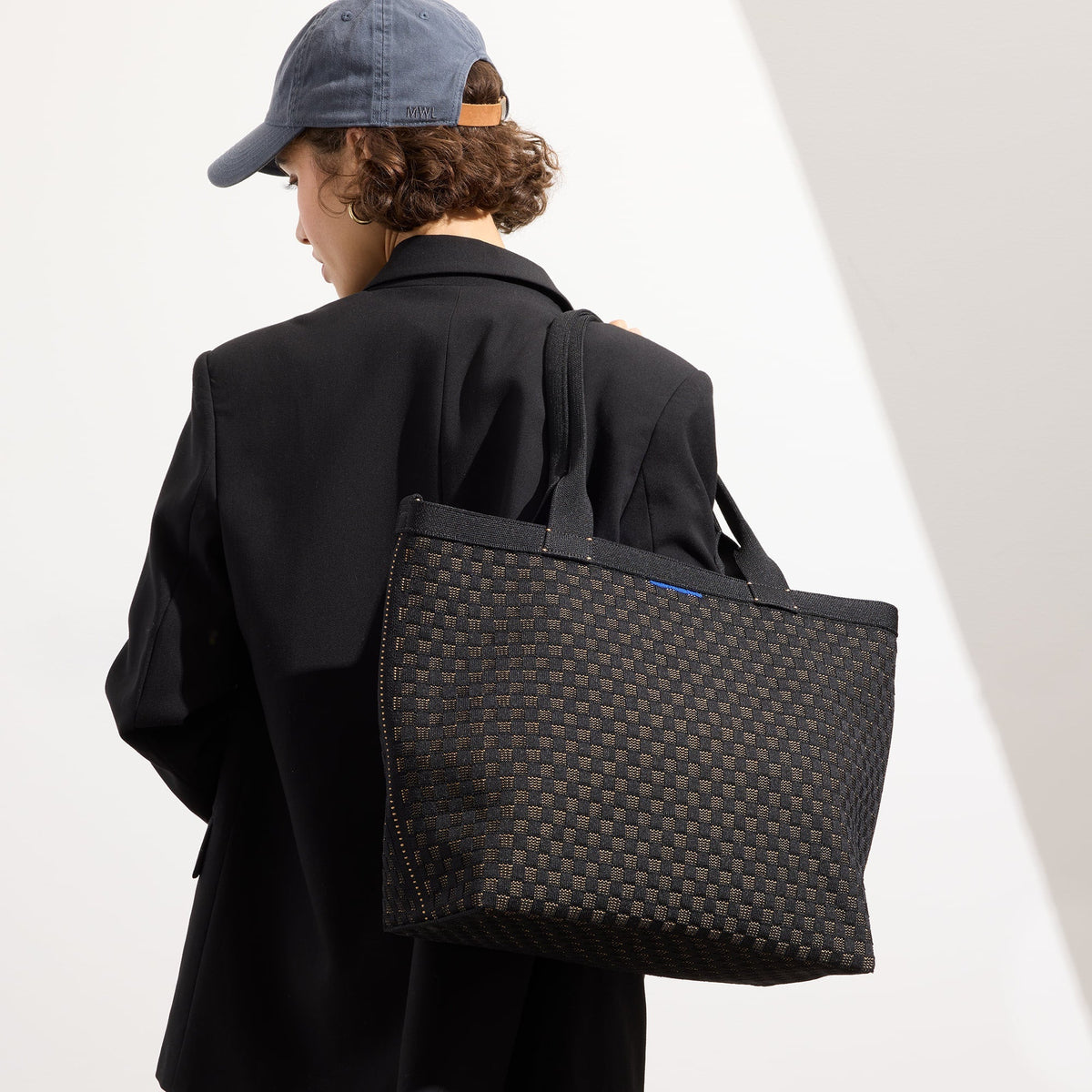 hover | Model holding The Lightweight Zip Tote in Night Song.