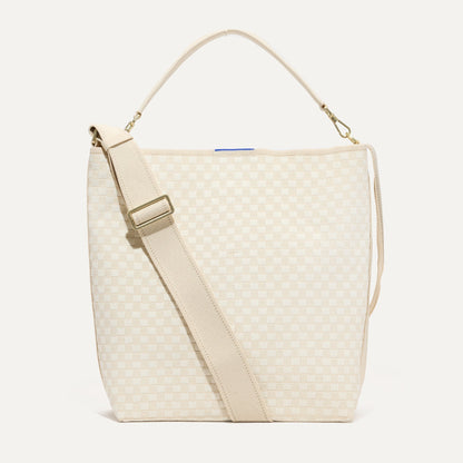The Bucket Bag in White Sand shown from the front.