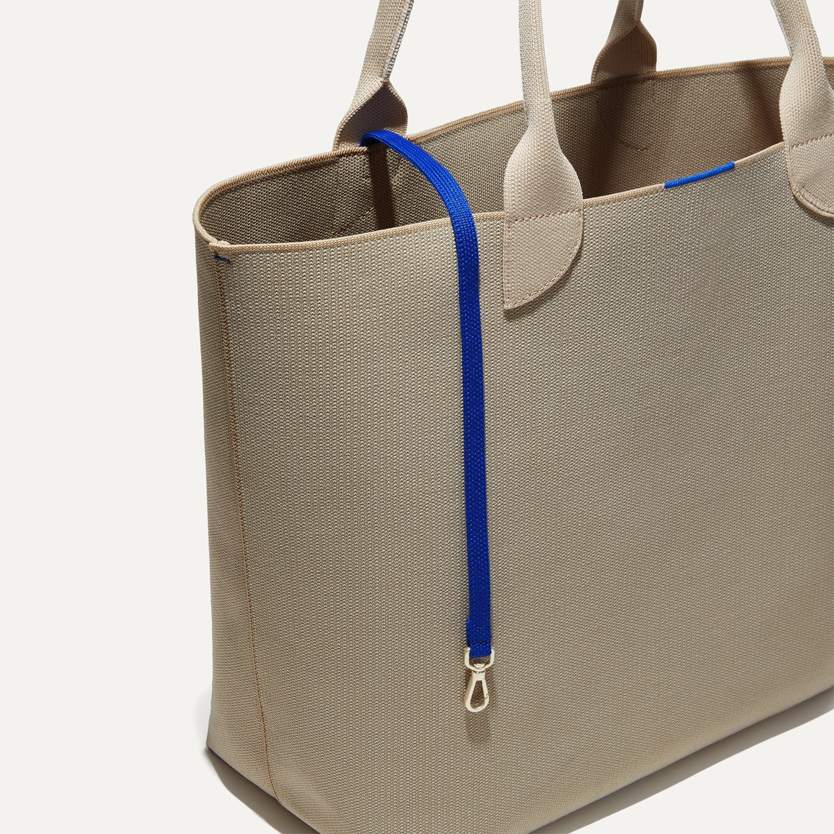 The Lighweight Tote in Soft Sesame shown with its handy key leash.