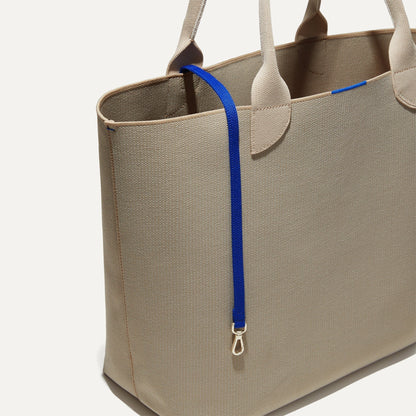 The Lighweight Tote in Soft Sesame shown with its handy key leash.