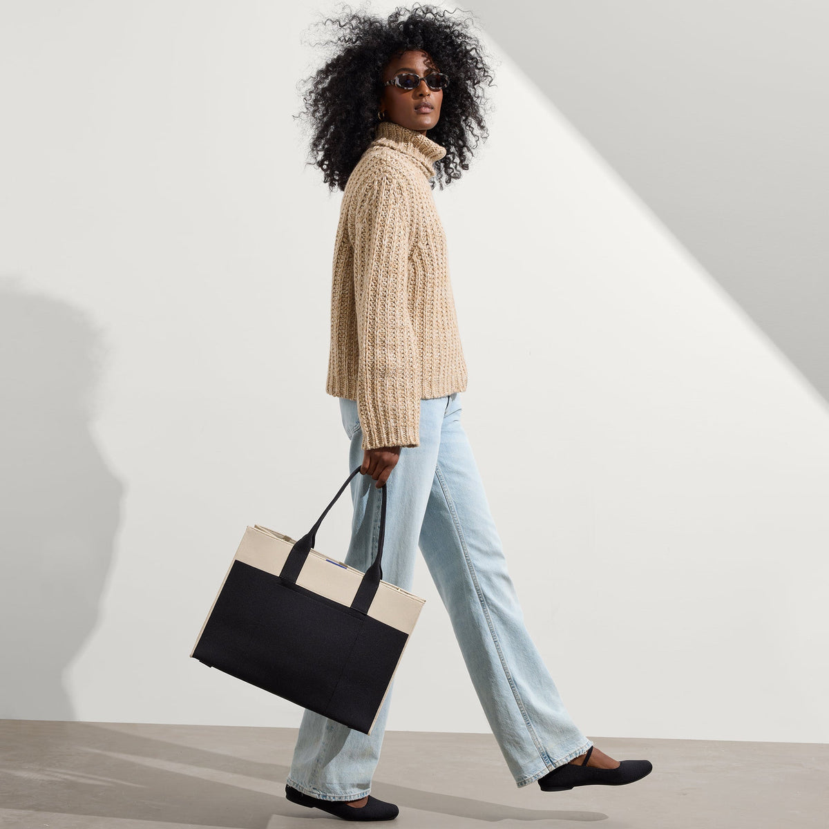 hover | The Classic Tote in Luna, worn over the shoulder by a model, shown from the side.