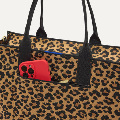A closeup of The Classic Tote in Toasty Cat, focusing on the exterior zip pocket.