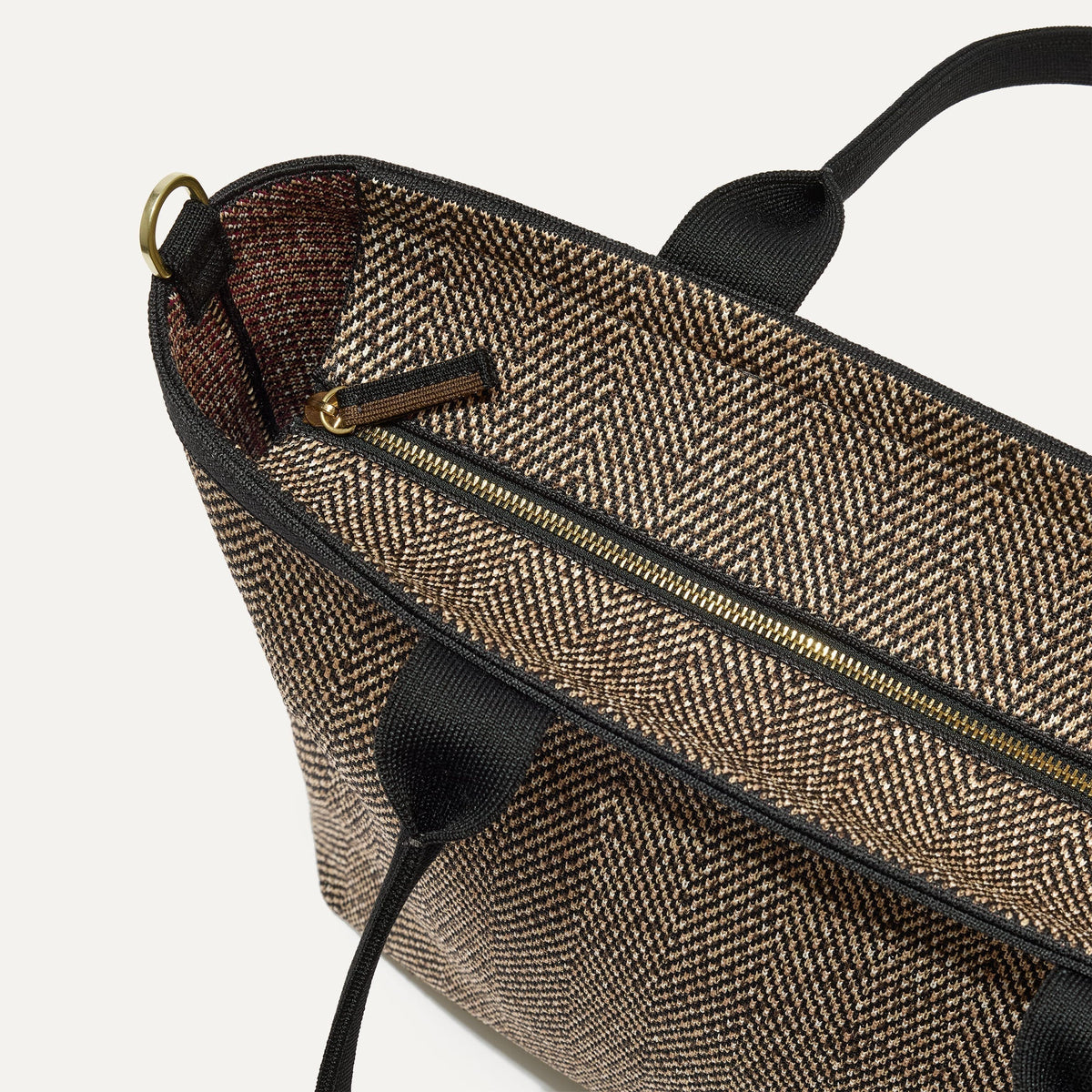 The Lightweight Zip Tote in Cacao Herringbone focusing on the zip closure and handles