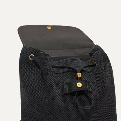 The Cinch Backpack shown with the interior exposed showing the organizational pockets.