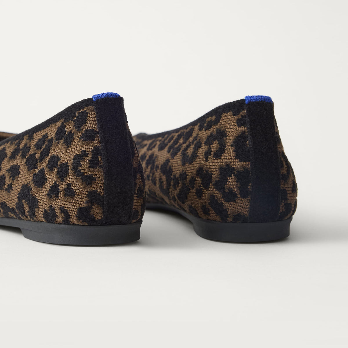 Close up of the heel of The Max Square Ballerina in ReVelvet Spotted Cat with Rothy's signature blue halo.